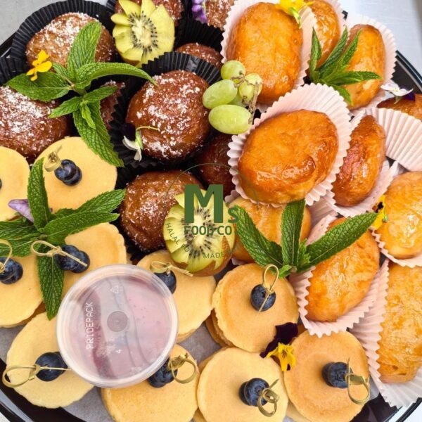 Halal cape malay breakfast platter with koesisters, donuts and flapjacks