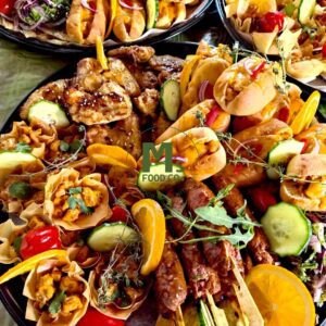 Halal indulgent platter with chicken wings, mini wraps, beef koftas with roti, and chicken tikka phyllo cups by Mβs Food Co.